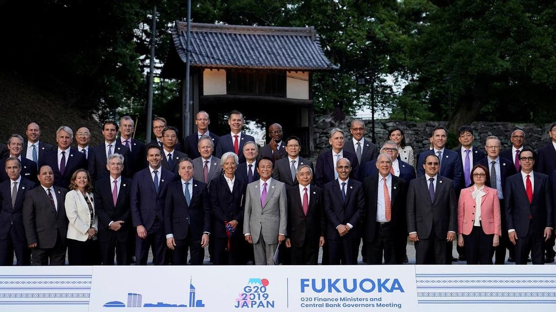 Japan's Finance Minister Taro Aso poses next to IMF Managing Director Christine Lagarde and Bank of Japan Governor Haruhiko Kuroda for a family photo during the G20 finance ministers and central bank governors meeting, in Fukuoka. (Reuters)