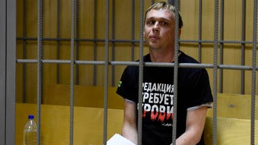 Ivan Golunov, a journalist who worked for the independent website Meduza, sits in a cage in a court room in Moscow, Russia, on June 8, 2019. (AP)