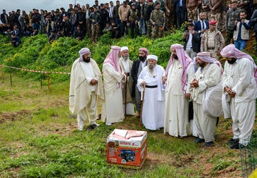 Iraqi Yazidi clerics attend the exhumation of a mass-grave of hundreds of Yazidis killed by Islamic State (IS) group militants in the northern Iraqi village of Kojo in Sinjar district on March 15, 2019. (AFP)