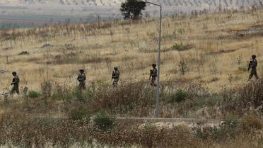 Turkish soldiers walk at the Atmeh crossing on the Syrian-Turkish border, as seen from the Syrian side, in Idlib governorate, Syria May 31, 2019. REUTERS