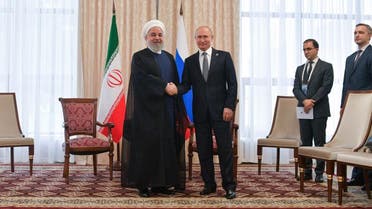 File photo of Hassan Rouhani (left) and Vladimir Putin (right) shaking hands. (AFP)