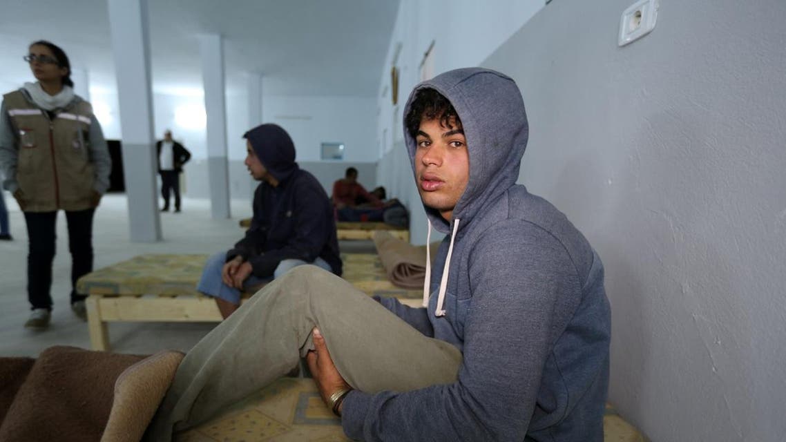 A survivor of a boat carrying migrants that sunk in the Mediterranean during the night of 9 and 10 May, rests at a shelter in the Tunisian coastal city of Zarzis on May 11, 2019. (AFP)