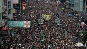 Huge crowds march in Hong Kong, piling pressure on leader