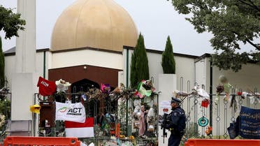 An armed police officer (R) stands guard outside the Al Noor mosque, in Christchurch, where more than 50 people were killed. (AFP)