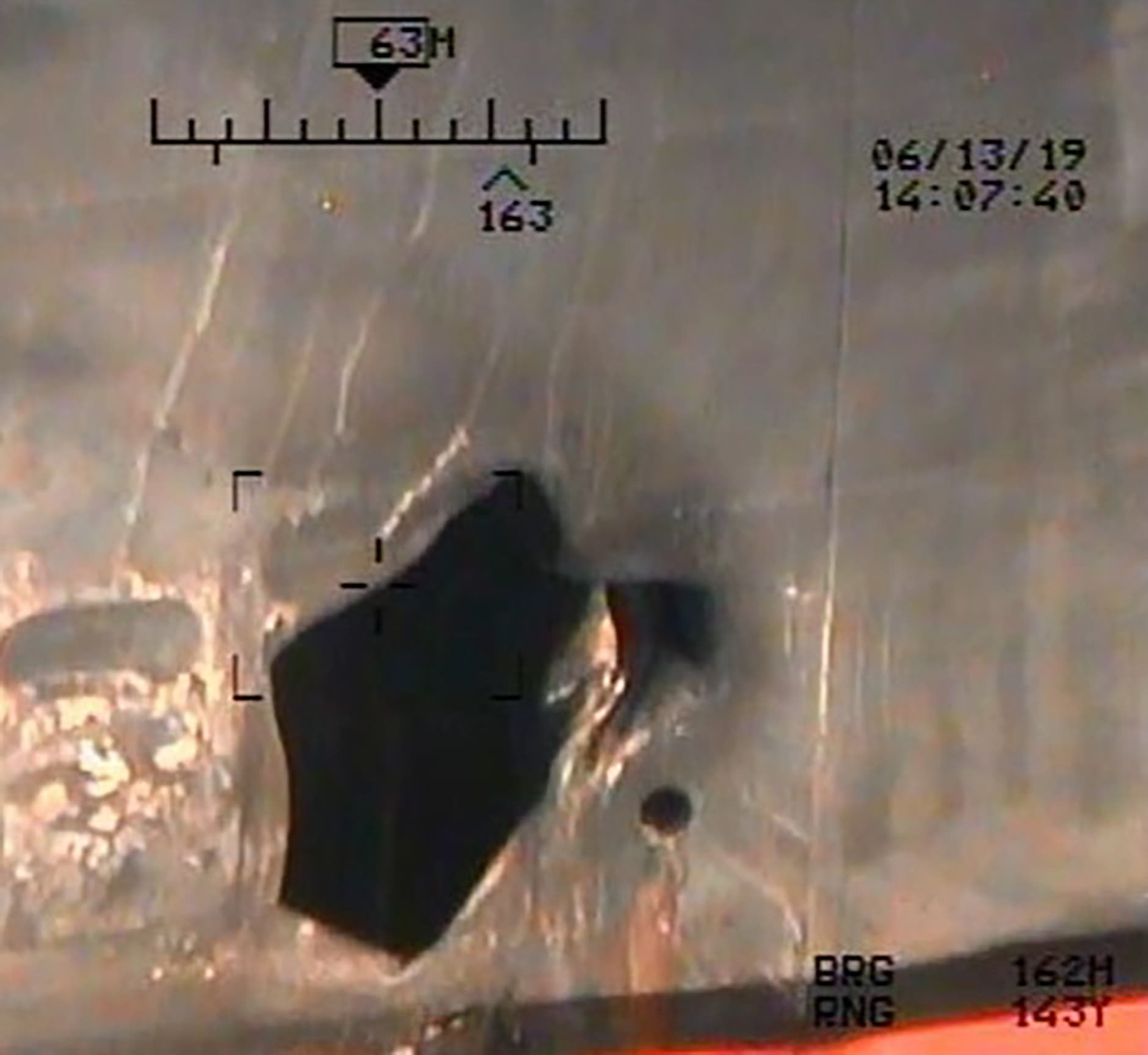 One of the photos released Monday shows what the Pentagon described as “the remnants of the magnetic attachment device of (an) unexploded limpet mine,” while others picture the place where the mine was allegedly attached. (AFP)