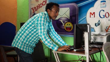 Kaleb Alemayehu, the owner of an internet cafe in the city of Adama, checks a computer on April 4, 2018. (File photo: AFP)