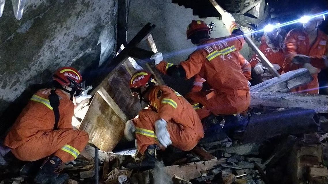 Rescuers search for earthquake survivors in the rubble of a building in Yibin early on June 18, 2019. (AFP)