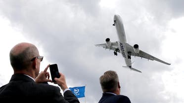 A visitor takes a picture of an Airbus A350-1000 as it performs during the 53rd International Paris Air Show at Le Bourget Airport near Paris, France on June 19, 2019. (Reuters)