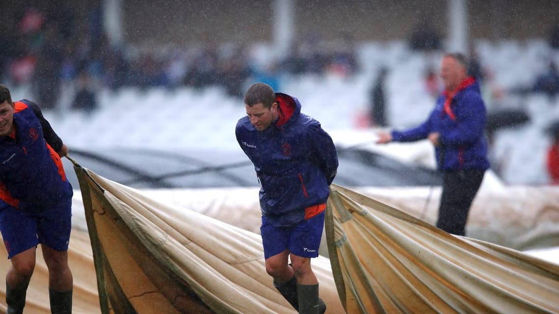 Ground staff put covers on the pitch as rain delays play at Trent Bridge, Nottingham, during the ICC Cricket World Cup match between India and New Zealand on June 13, 2019. (Reuters)