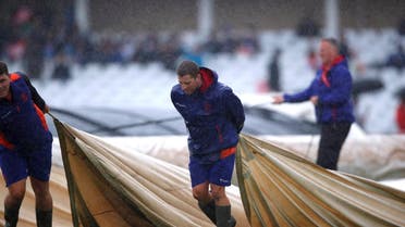 Ground staff put covers on the pitch as rain delays play at Trent Bridge, Nottingham, during the  ICC Cricket World Cup match between India and New Zealand on June 13, 2019. (Reuters)