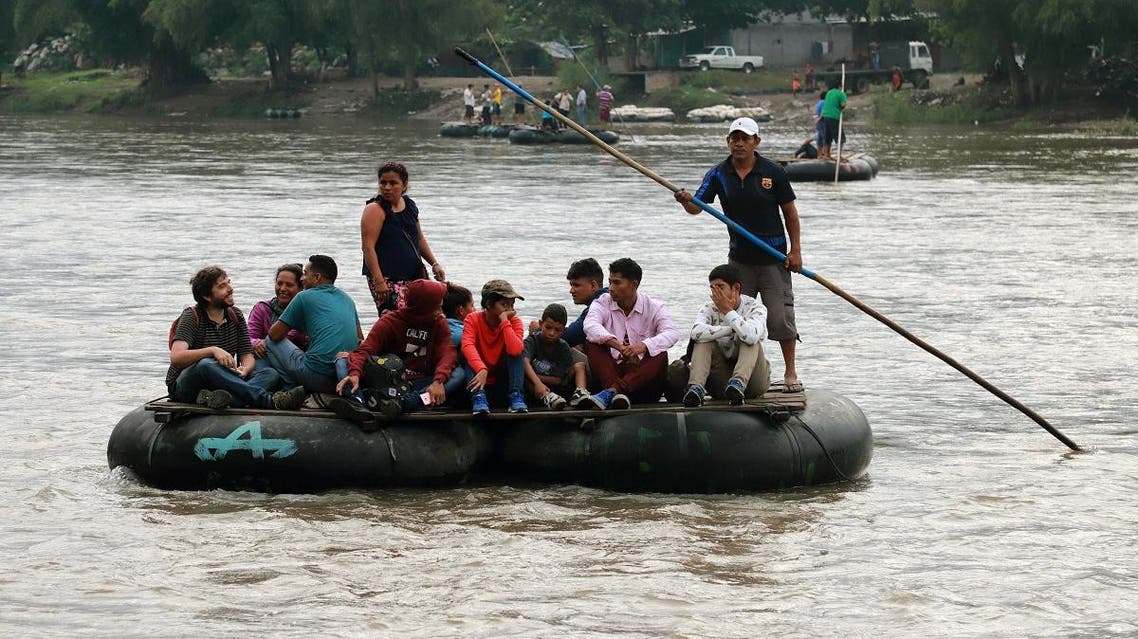 Locals and Central American migrants use a makeshift raft across the Suchiate river from Tecun Uman in Guatemala, to Ciudad Hidalgo in Chiapas State, Mexico. (AFP)