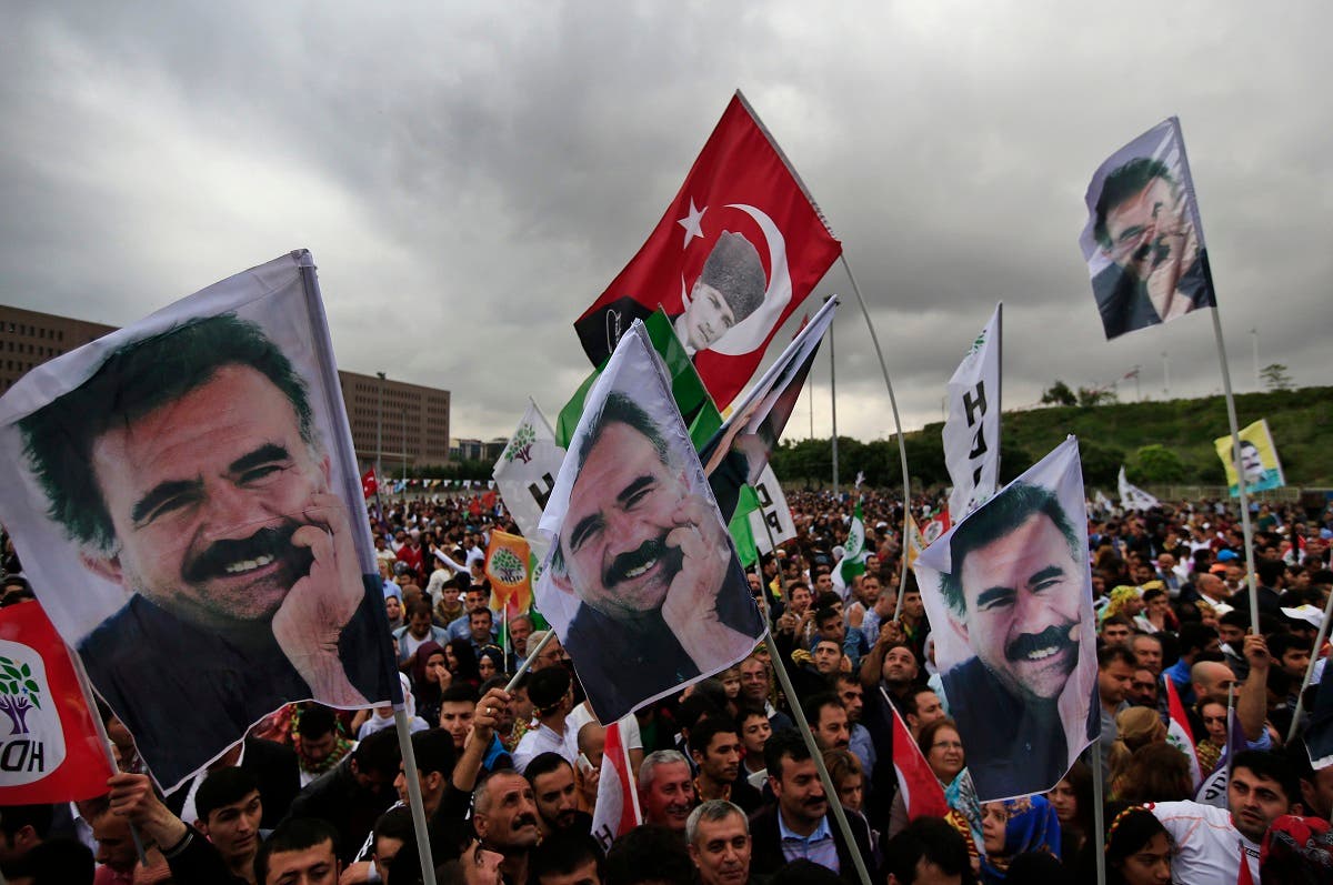 Supporters of the pro-Kurdish Peoples' Democratic Party, (HDP) wave a flag, centre, with Turkish Republic founder Mustafa Kemal Ataturk, and others of imprisoned Kurdish rebel leader Abdullah Ocalan, during a rally in Istanbul, Turkey, Monday, June 8, 2015. (AP)