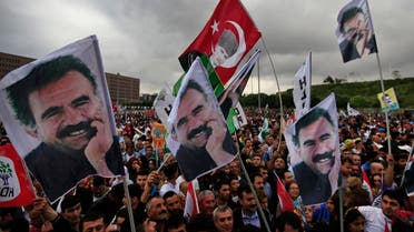 Supporters of the pro-Kurdish Peoples' Democratic Party, (HDP) wave a flag, centre, with Turkish Republic founder Mustafa Kemal Ataturk, and others of imprisoned Kurdish rebel leader Abdullah Ocalan, during a rally in Istanbul, Turkey, Monday, June 8, 2015. (AP)