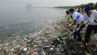 Volunteers remove rubbish washed ashore along the coastline of freedom island in Paranaque City. (File photo: AFP)