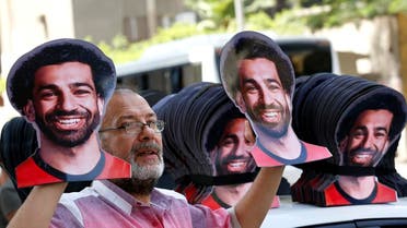 A vendor displays masks with pictures of Mohamed Salah ahead of the opening match between Egypt and Zimbabwe of the African Cup of Nations in Cairo, on June 21, 2019. (AP)