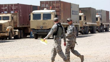 US soldiers walk past army trucks during a logistical operation to clear equipment and heavy machinery from the Balad military base, north of Baghdad. (File photo: AFP)