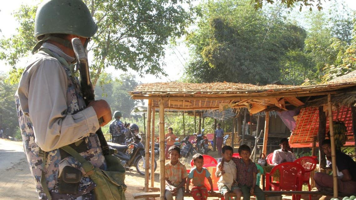 A Myanmar border guard policeman stand in front of a small store in a village are seen during a government-organized visit for journalists in Buthidaung townships in the restive Rakhine state. (File photo: AFP)
