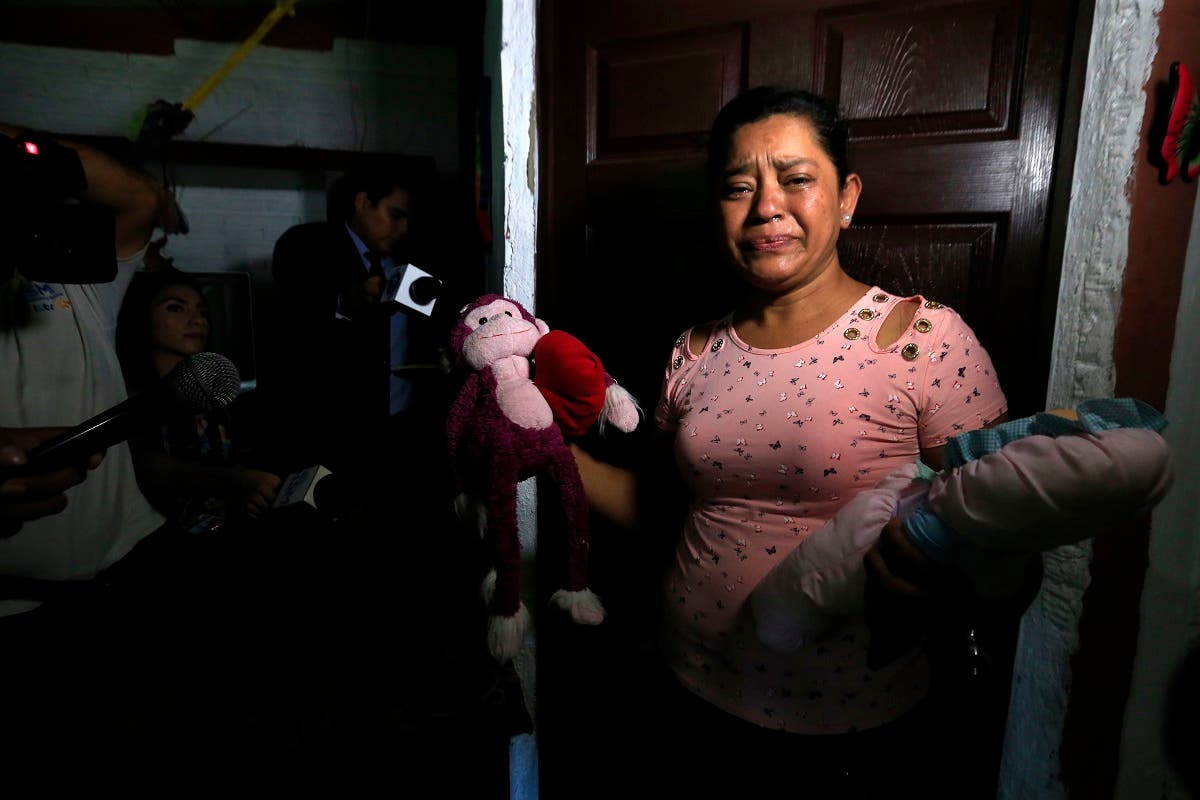 Rosa Ramirez sobs as she shows journalists toys that belonged to her nearly 2-year-old granddaughter Valeria in her home in San Martin, El Salvador. (AP)