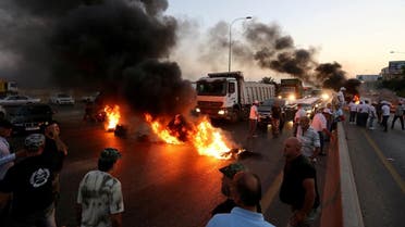 Lebanese army veterans burn tires during a protest over a state budget that includes a provision taxing their pensions, in Naameh, south of Beirut, Lebanon June 27, 2019. (Reuters)