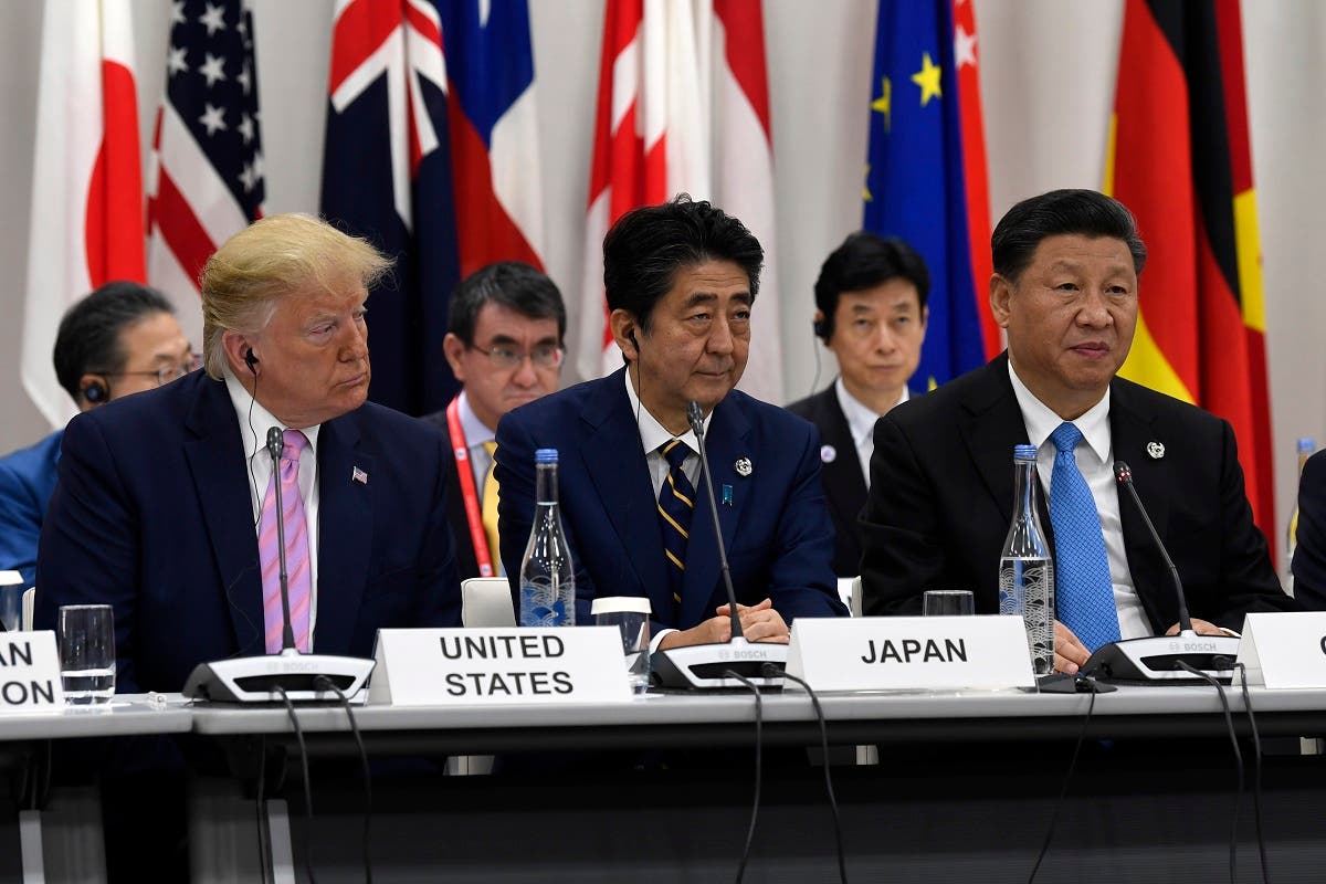 Chinese President Xi Jinping (right)speaks at the G-20 summit event on the Digital Economy in Osaka, Japan, on June 28, 2019. President Donald Trump and Japanese Prime Minister Shinzo Abe listen. (AP)