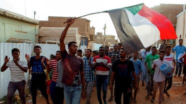 Sudanese protesters chant slogans and wave their national flag as they demonstrate against the ruling military council, in Khartoum. (File photo: Reuters)