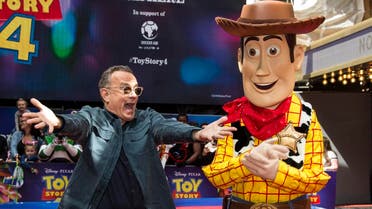 Actor Tom Hanks poses for photographers with his Toy Story character 'Woody', upon arrival at the screening for 'Toy Story 4' in London, Sunday, June 16, 2019. (AP)