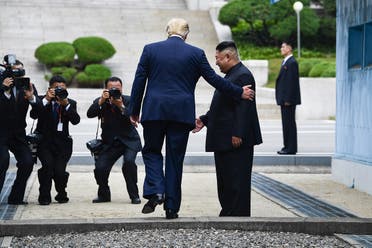 US President Donald Trump steps into the northern side of the Military Demarcation Line that divides North and South Korea, as North Korea’s leader Kim Jong Un looks on, on June 30, 2019. (AFP)