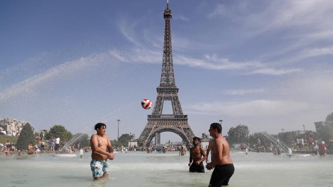 People play as they bathe in the Trocadero Fountain in front of the Eiffel Tower in Paris during a heatwave on June 28, 2019. (AFP)
