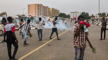 Sudanese protesters cover their faces against tear gas fumes during clashes with security forces in the capital Khartoum on June 30, 2019. (AFP)