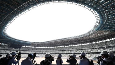 Members of the media visit the new National Stadium under construction, a venue for the upcoming Tokyo 2020 Olympic Games, in Tokyo on July 3, 2019. (AFP)