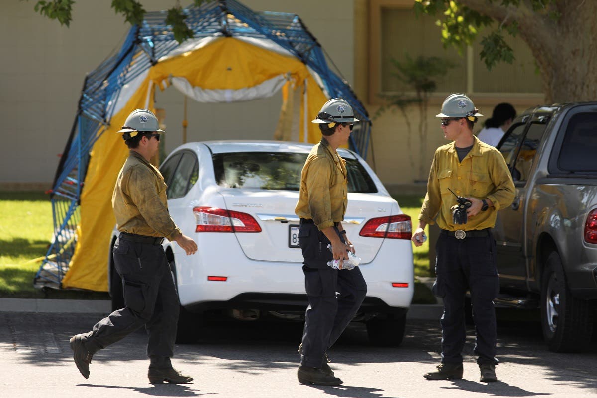 Wildland firefighters pass by hospital equipment being set up outside the Ridgecrest Regional Hospital after a powerful earthquake struck Southern California in the city of Ridgecrest, California, US, on July 4, 2019. (Reuters)