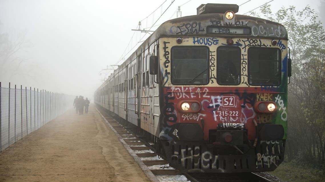 Migrants and refugees arrive to a make-shift train station in Sentilj to cross the Slovenian-Austrian border on November 1, 2015. At least 13 migrants, six of them children, drowned as two boats making the hazardous crossing from Turkey capsized in separate incidents in the Aegean Sea off Greece on November 1, the coastguard said. Ten bodies -- including six children, four of them babies -- were found in the vessel's cabin while that of a girl was washed up on the island, where dozens of refugees have perished trying to reach Europe in recent days. AFP PHOTO / RENE GOMOLJ