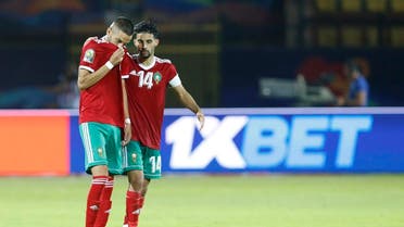 Morocco's Hakim Ziyach. left, and M'brak Boussoufa leave pitch dejected after the African Cup of Nations round of 16 soccer match between Morocco and Benin in Al Salam stadium in Cairo, Egypt, Friday, July 5, 2019. (AP)