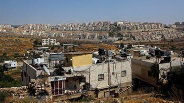A view shows Palestinian houses in the village of Wadi Fukin as the Jewish settlement of Beitar Illit is seen in the background, in the Israeli-occupied West Bank. (Reuters)