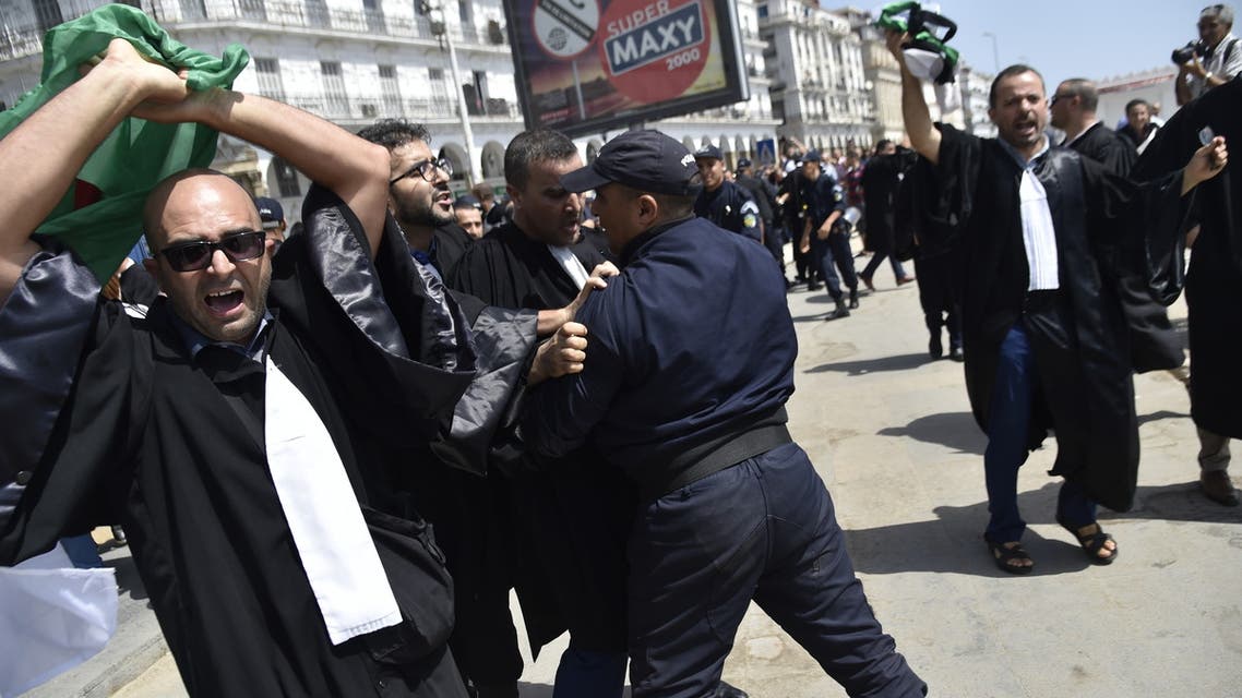 Lawyers rally for change in the streets of the Algerian capital Algiers on July 11 2019, in the latest in weeks of rallies against the ruling class amid an ongoing political crisis in the country. French and Arabic slogans on placards read: Liberty of Expression (R), Yes for the Independence of the judiciary (C) and Freedom (L). Algeria has been rocked by months of demonstrations, forcing longtime president Abdelaziz Bouteflika to step down in April. Protesters have continued to take to the streets, demanding that regime insiders leave office and independent institutions be established ahead of eventual elections.