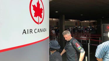 Passengers from an Australia-bound Air Canada flight diverted to Honolulu on July 11, 2019, after about 35 people were injured during turbulence, stand in line at the Air Canada counter at Daniel K. Inouye International Airport to rebook flights. (AP)