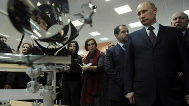 File photo of Vladimir Putin, (right front), looking at an X-ray mirror of space telescope during his visit to the Sarov nuclear center, former Arzamas-16, near Nizhny Novgorod, Russia. (AP)