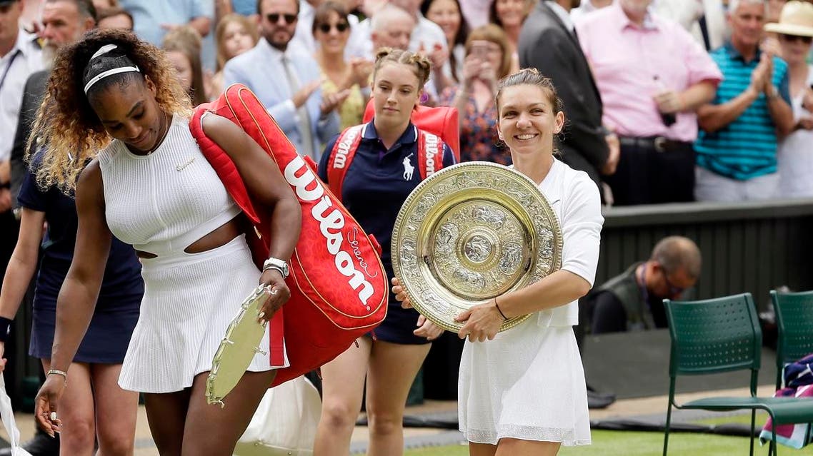Simona Halep walks away with her trophy after defeating Serena Williams (left), in the women’s singles final match on day 12 of the Wimbledon Tennis Championships in London, on July 13, 2019. (AP)