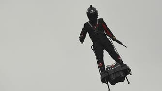 French inventor soars above Champs-Elysees on flyboard at Paris parade