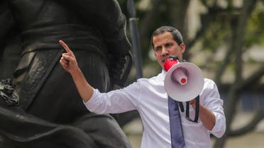 Venezuela's opposition leader and self-proclaimed interim president Juan Guaido speaks by the statue of Venezuelan procer Francisco de Miranda during a march against the government (AP)