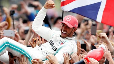 Mercedes' Lewis Hamilton celebrates with the crowd after winning the race. (Reuters)
