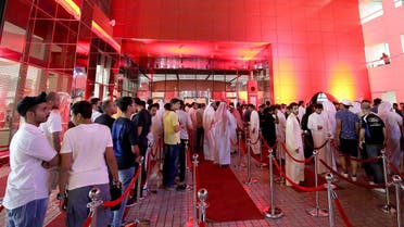 A crowd of people wait outside a telecommunications company headquarters to purchase the new Apple iPhone 8 in Kuwait City. (File photo:AFP)