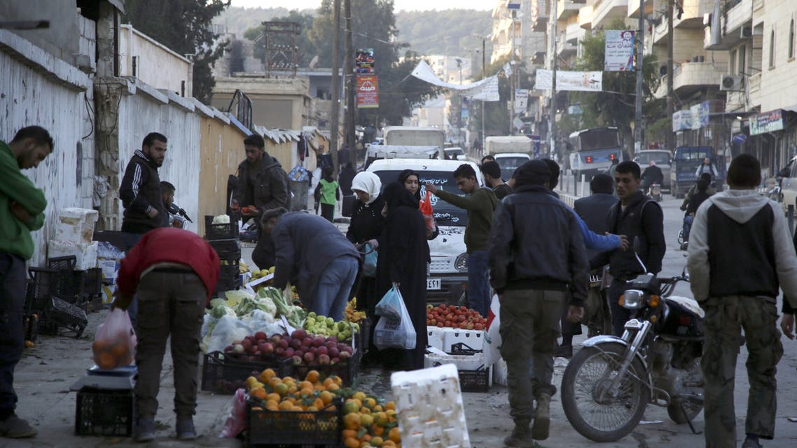 Displaced Syrians move with their belongings to drying areas in a flooded camp near Dayr Ballut, in the Afrin region of the rebel-held Aleppo province in northwestern Syria, on January 9, 2019. The Afrin river overflowed due to torrential rain and snow storms lashing the region, which washed away hundreds of tents in camps sheltering displaced Syrians in the north of the war-wracked country, according to aid groups.