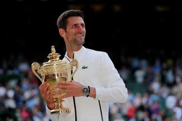 Novak Djokovic with the Wimbledon trophy as he celebrates winning the final against  Roger Federer at the All England Lawn Tennis and Croquet Club, London, on July 14, 2019. (Reuters)
