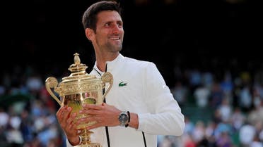 Novak Djokovic with the Wimbledon trophy as he celebrates winning the final against  Roger Federer at the All England Lawn Tennis and Croquet Club, London, on July 14, 2019. (Reuters)