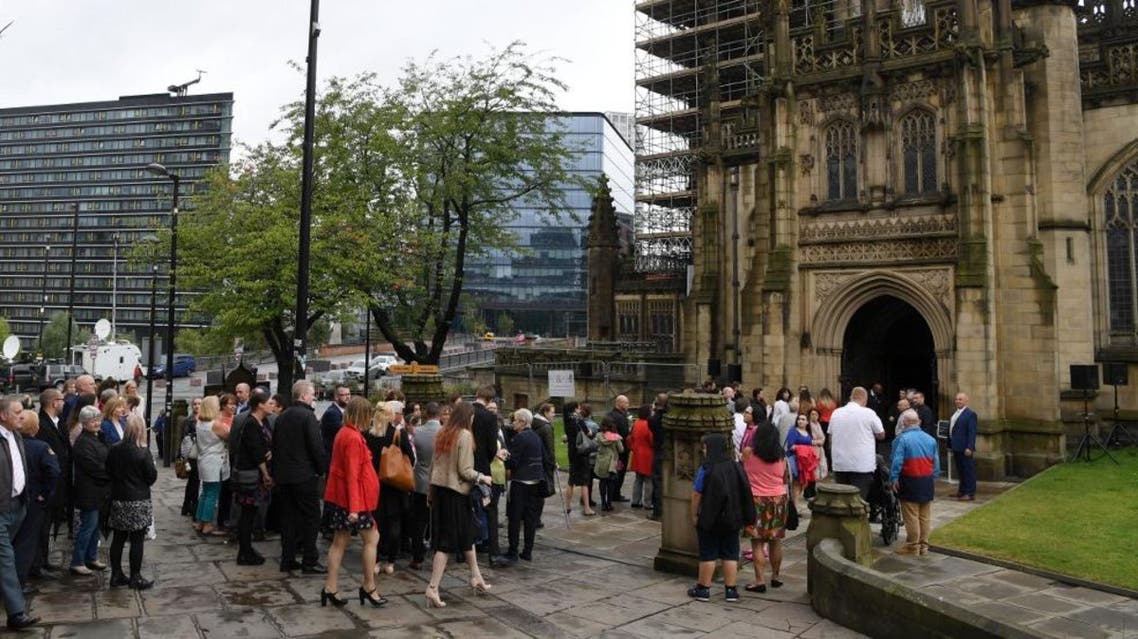 Funeral attendees, who were requested to bring a rose, arrive for the funeral of Manchester Arena bomb victim Saffie-Rose Roussos AFP