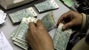 An employee at Lebanon's Central Bank counts money bills at his office in Beirut on November 24, 2008. (AFP)