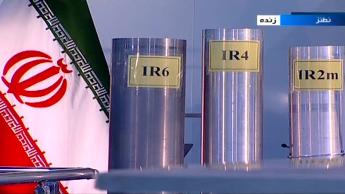 In this June 6, 2018 frame grab from Islamic Republic Iran Broadcasting, IRIB, state-run TV, three versions of domestically-built centrifuges are shown in a live TV program from Natanz, an Iranian uranium enrichment plant, in Iran. The program from made a point to show the centrifuges labeled in English in the background. Those shown Wednesday night are more-sophisticated devices Tehran is currently prohibited from running under the nuclear deal with world powers. (IRIB via AP)