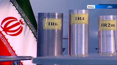 In this June 6, 2018 frame grab from Islamic Republic Iran Broadcasting, IRIB, state-run TV, three versions of domestically-built centrifuges are shown in a live TV program from Natanz, an Iranian uranium enrichment plant, in Iran. The program from made a point to show the centrifuges labeled in English in the background. Those shown Wednesday night are more-sophisticated devices Tehran is currently prohibited from running under the nuclear deal with world powers. (IRIB via AP)