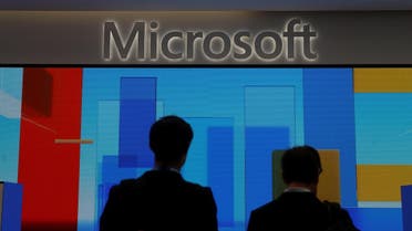 Visitors stand in front of a display screen at Microsoft’s new Oxford Circus store in London, Britain. (Reuters)